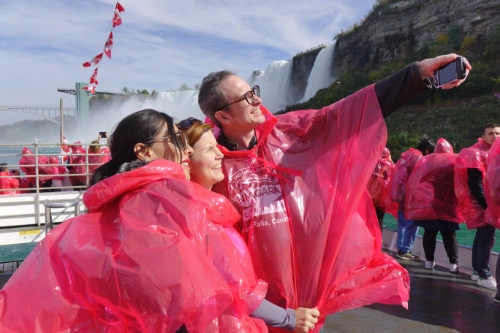 guests on Niagara Falls tour boat taking a photo